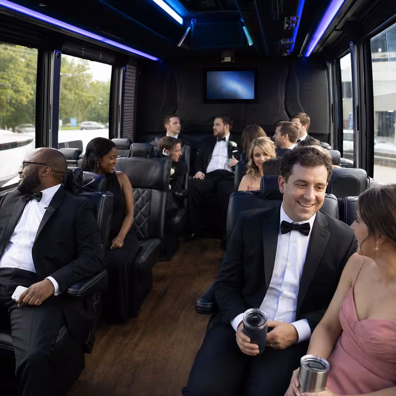 Wedding guests seated inside a Arlington party bus