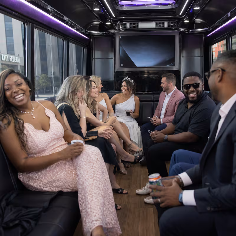 Party bus interior with wraparound leather seating and LED lighting in Arlington