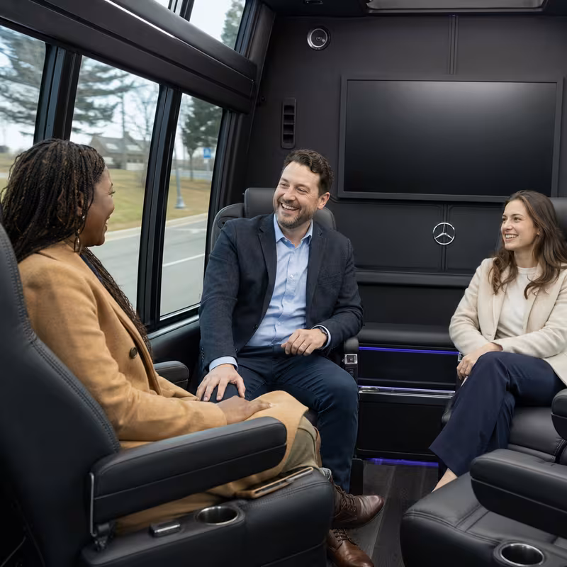 Group boarding a white charter bus for Corporate Transportation transportation in Arlington
