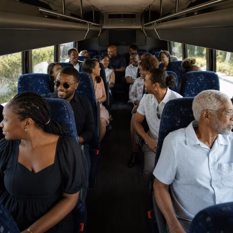 Group boarding a white charter bus for Private Event Transportation transportation in Arlington