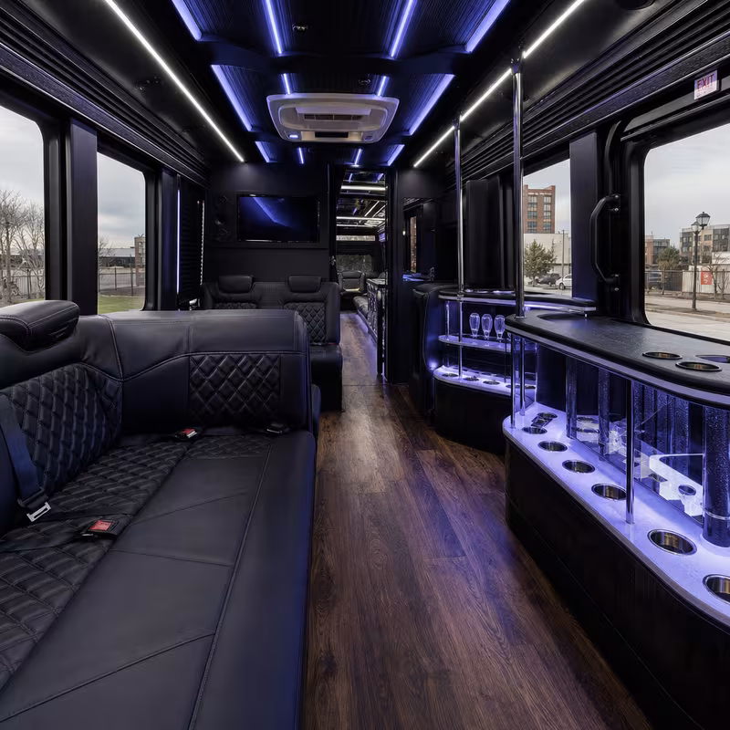 Party bus interior with wraparound leather seating and LED lighting in Arlington