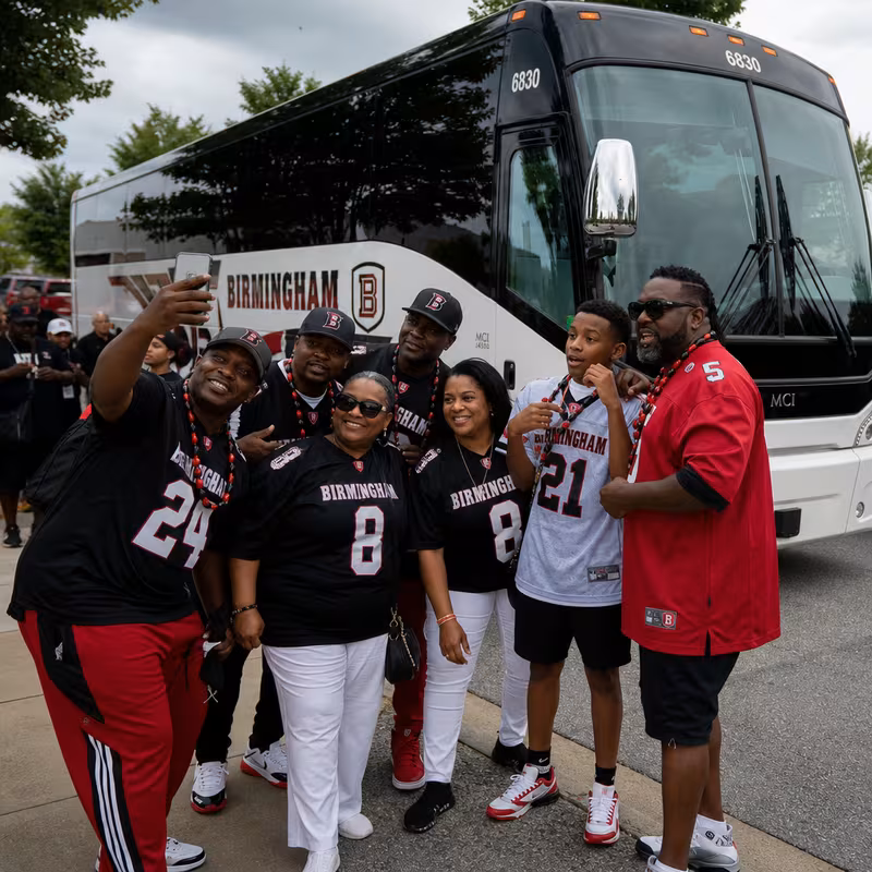 Passengers loading luggage while boarding an Arlington group shuttle