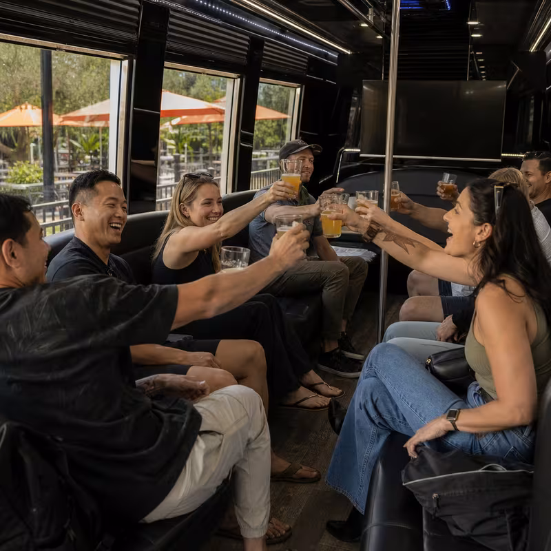 Group boarding a white charter bus for Winery & Brewery Tour Transportation transportation in Arlington