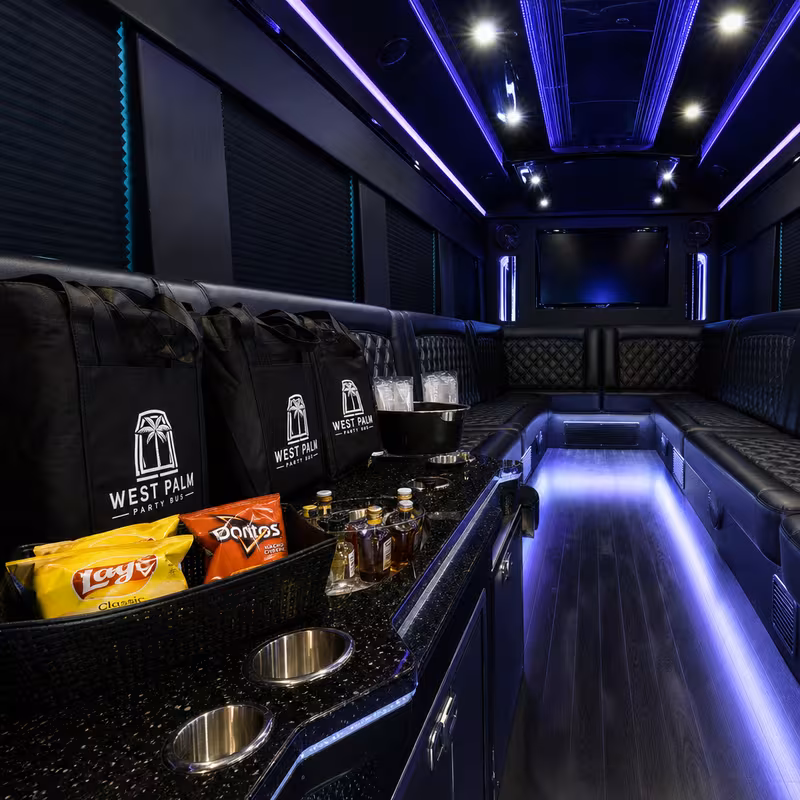 Party bus interior with wraparound leather seating and LED lighting in Arlington